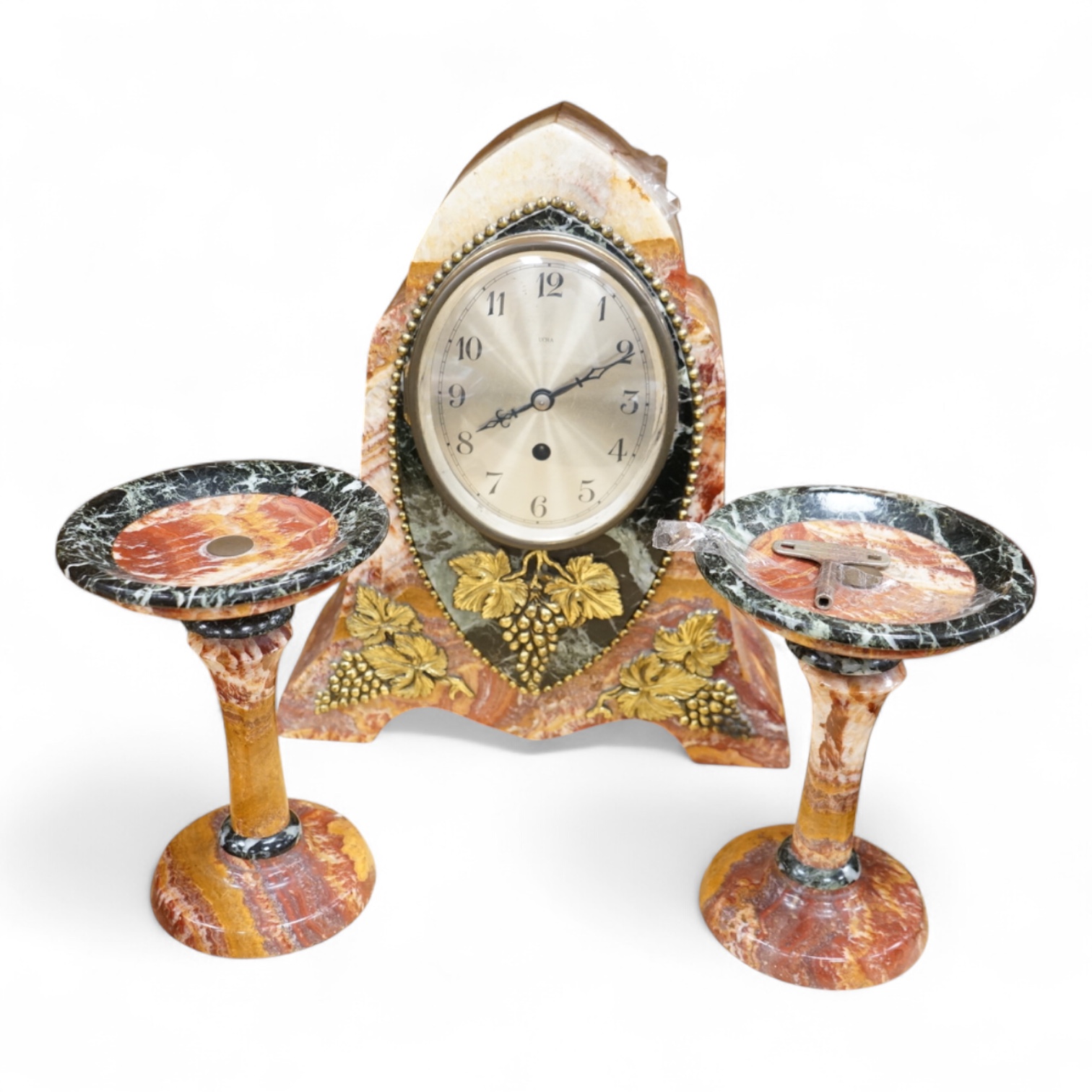 An early 20th century French rouge and black marble clock garniture with ornamental grape motif mounts to the clock and with a key, clock 34.5cm high